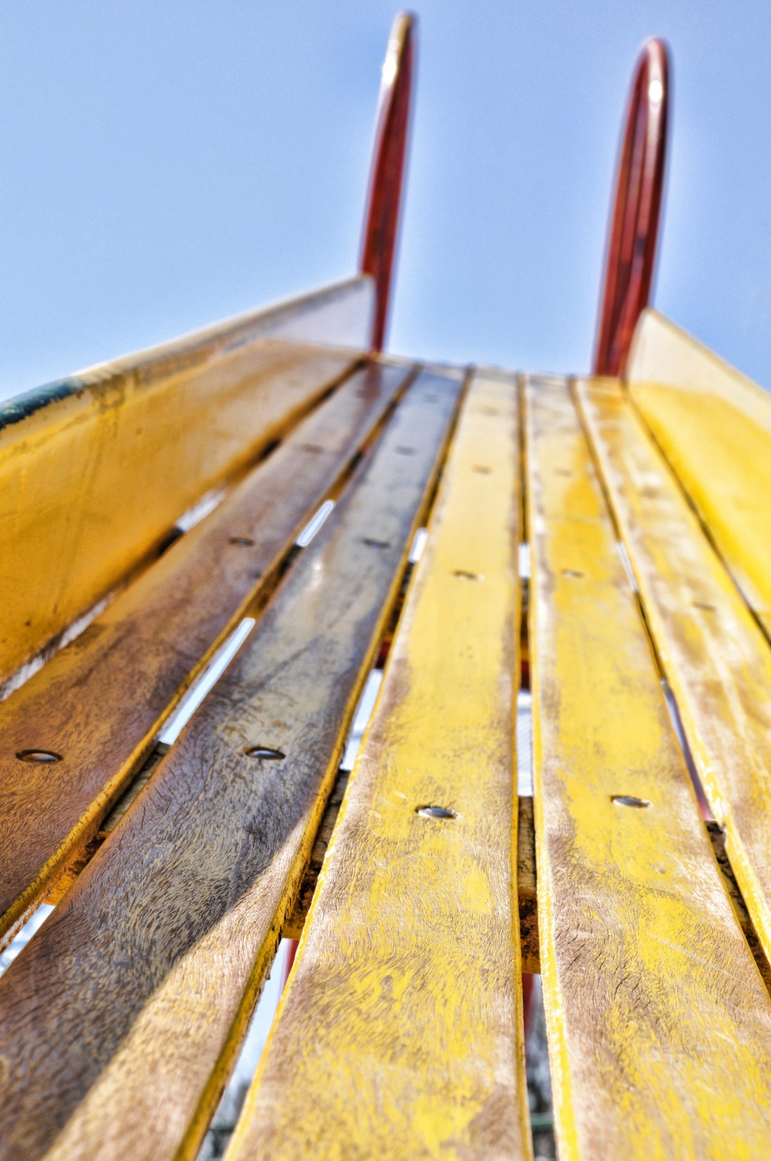 Capture the essence of tranquility with this stunning image of a rustic wooden bench set against a brilliant blue sky. Ideal for outdoor-themed projects, lifestyle blogs, and nature-inspired designs, this photograph evokes a sense of peace and relaxation. Whether used in marketing materials, social media posts, or as part of a personal collection, this serene scene invites viewers to imagine themselves enjoying a moment of solitude in nature.