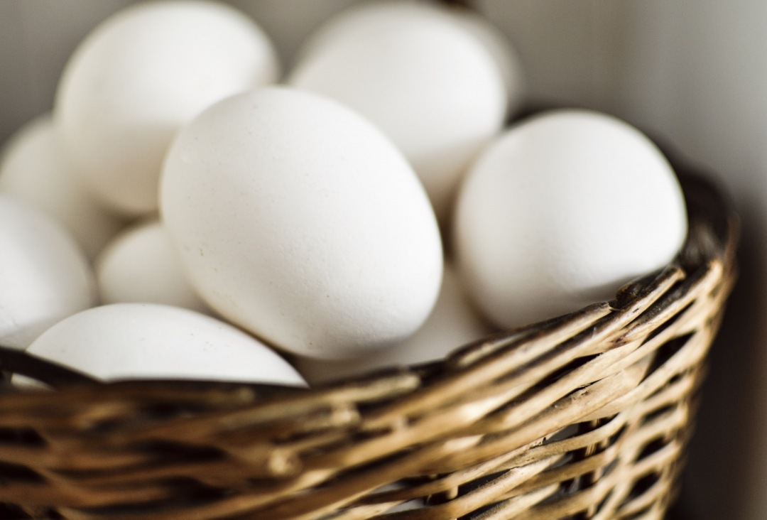 wicker basket of white eggs