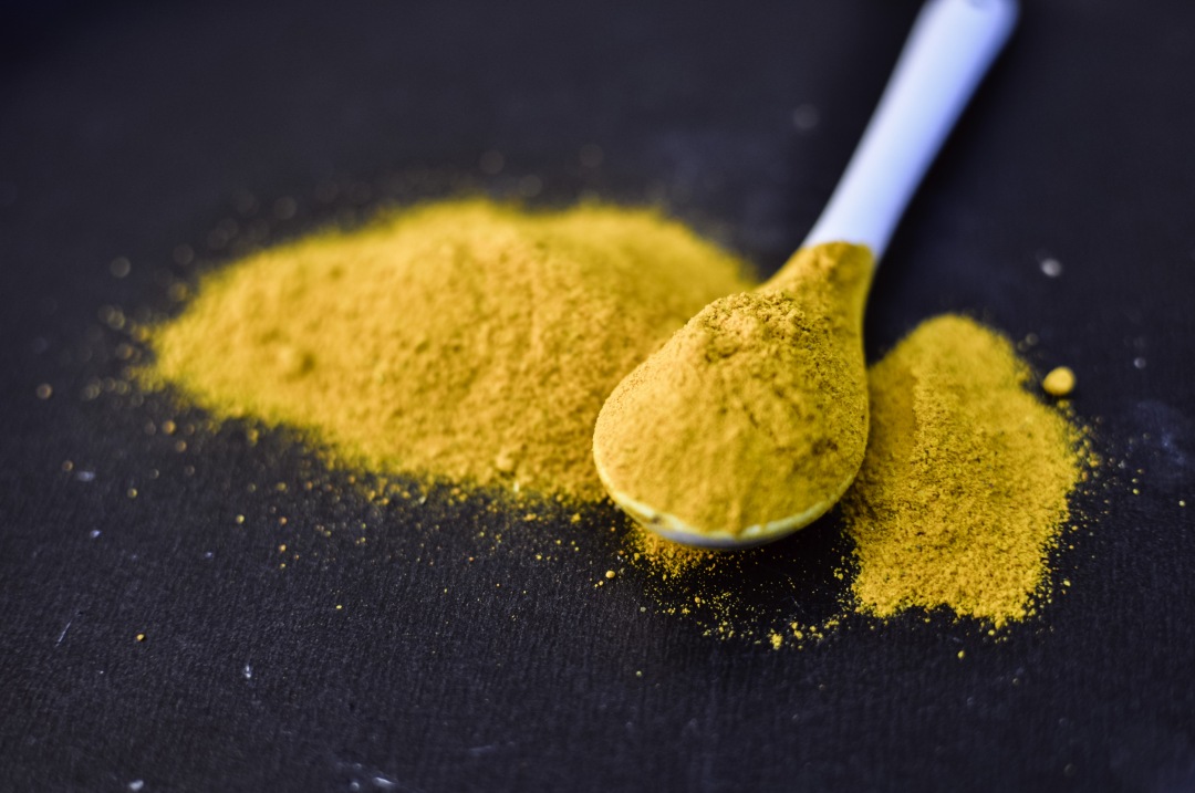 heap of curcuma powder isolated on Black background