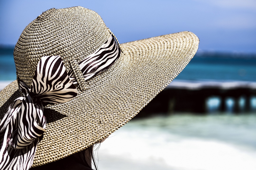 girl with hat on caribean beach