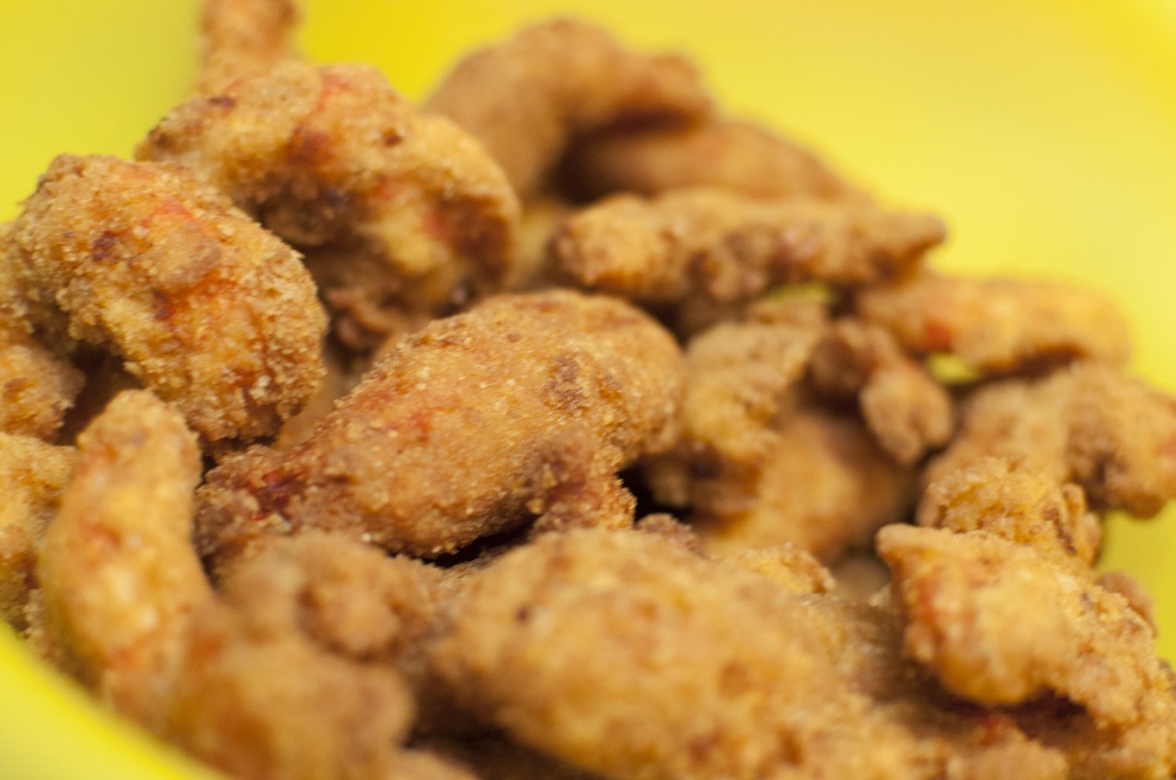 a yellow bowl filled with fried chicken