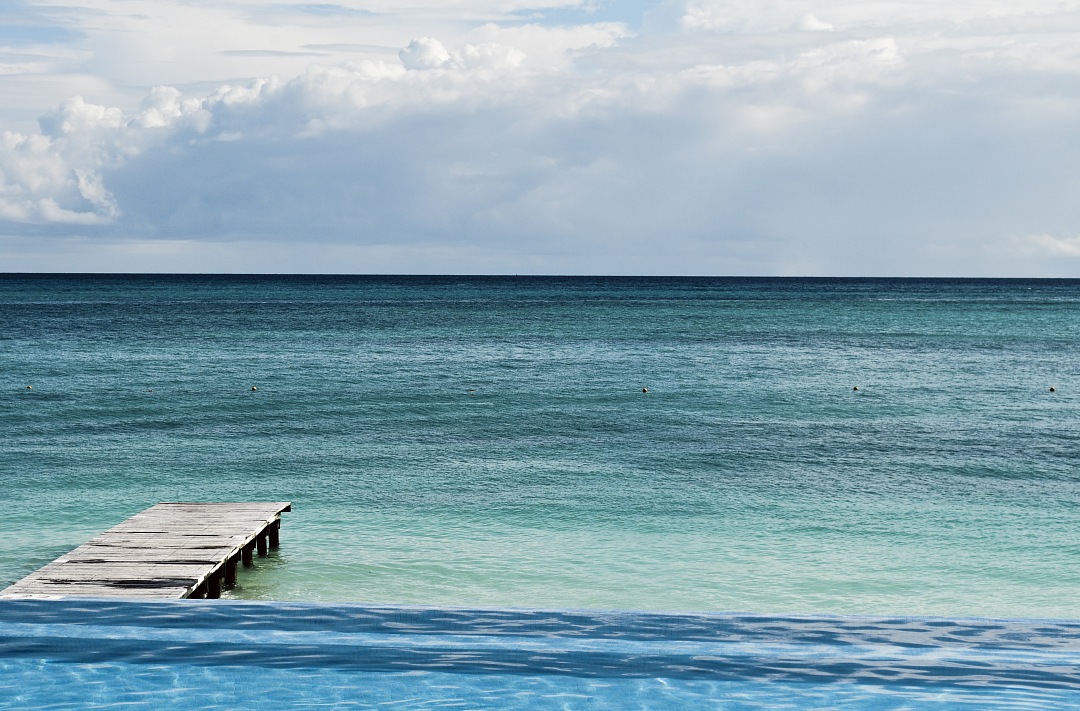 a pool with a dock in the middle of it