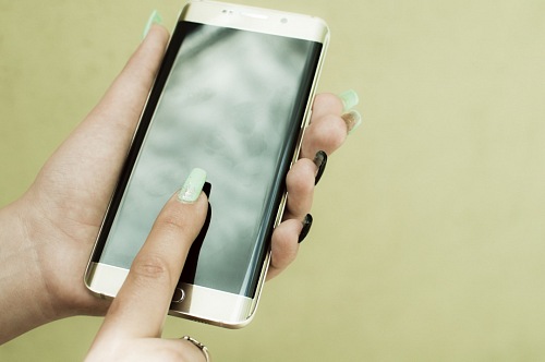 Woman's hands using smartphone 