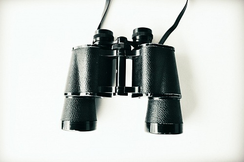 vintage binoculars over white background