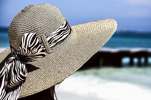 girl with hat on caribean beach
