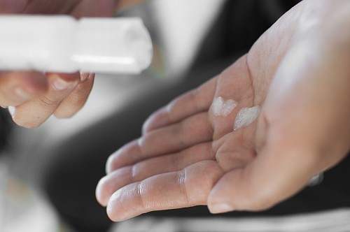 Latin women washing hands with Alcohol gel sanitizer on Home Office quarantine  