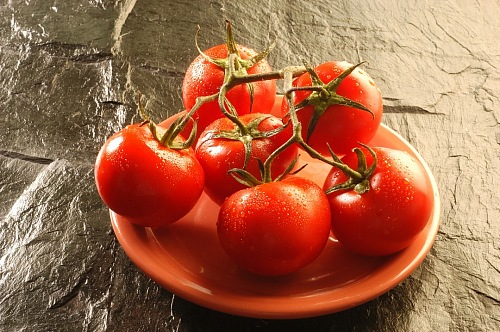 bunches of red tomatoes on a plate